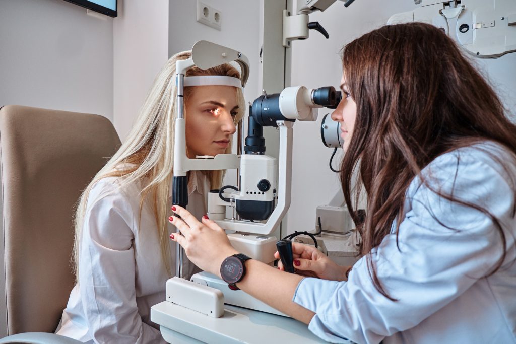 Woman Is Checking Her Sight At Optician Cabinet