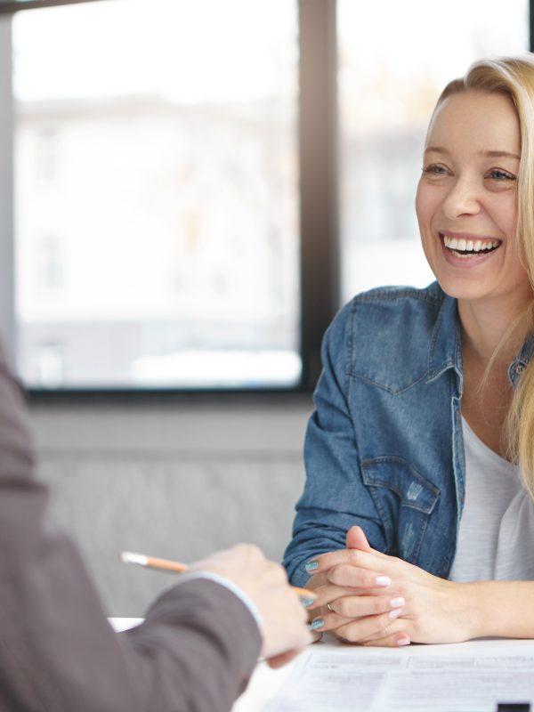 Happy Blonde Female Manager In Fashionable Clothes Has Pleasant Conversation With Male Colleague, Discuss Successful Strategy For Startup, Chaeck List Of Affairs, Consult New Project Together