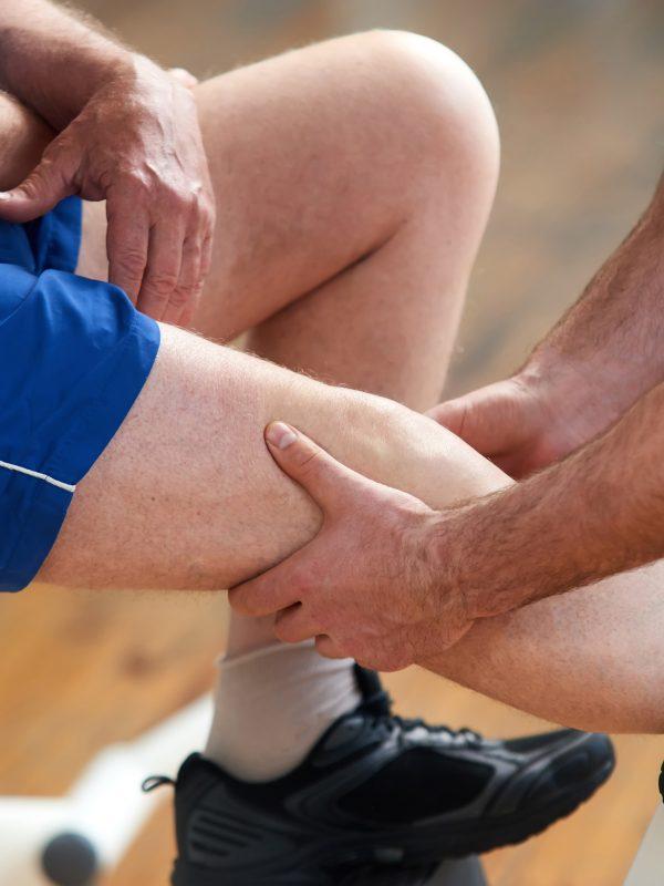 Man Suffering From Pain In Leg After Sport Exercise.