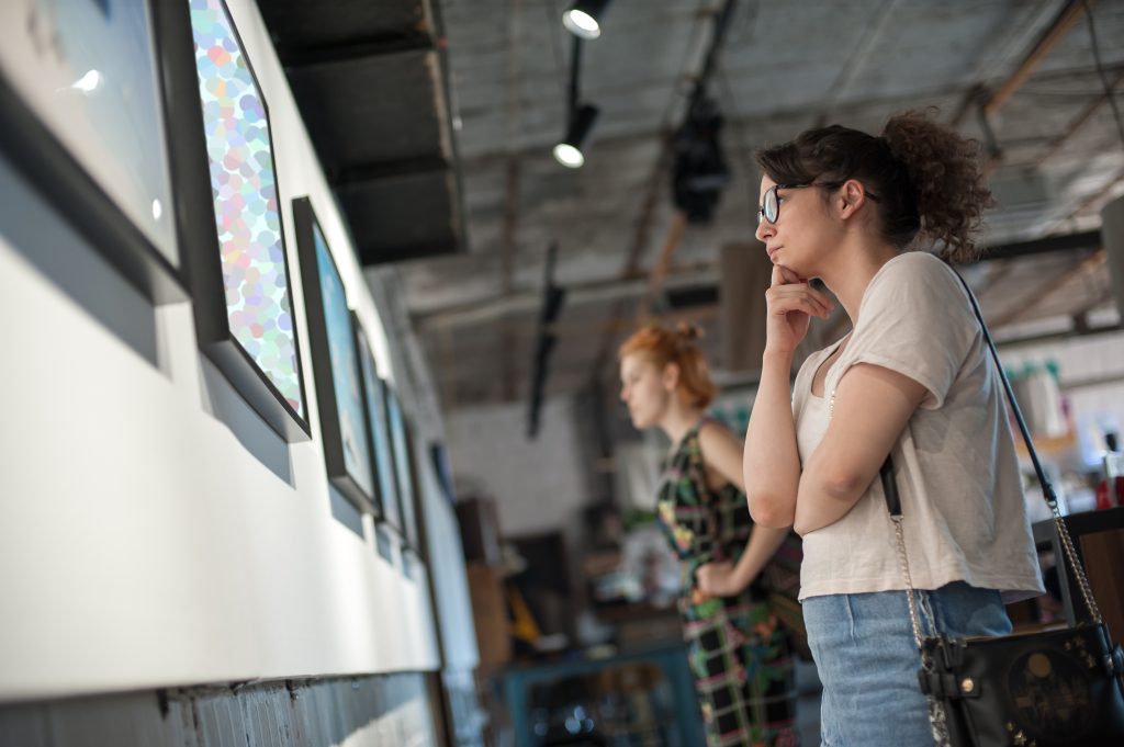 Two Girl Friends In Modern Art Exhibition Gallery Hall